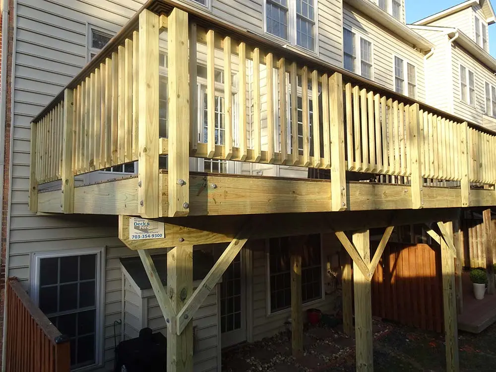 Second floor hybid deck providing cover for ground floor house entrance