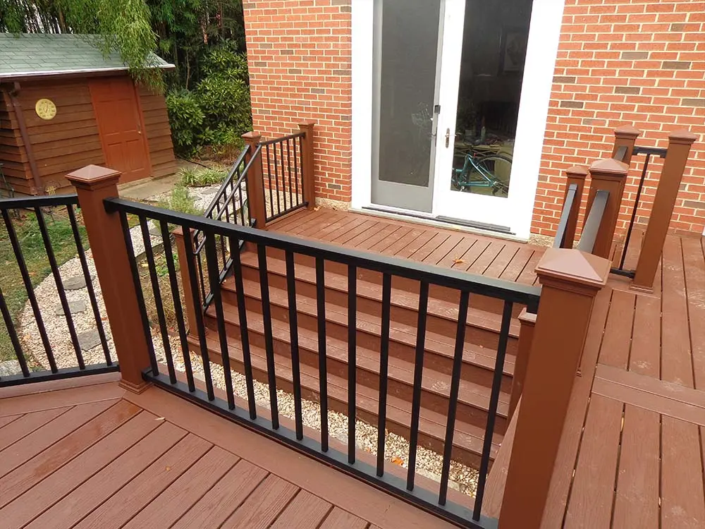 Composite & PVC Deck that wraps around red brick house