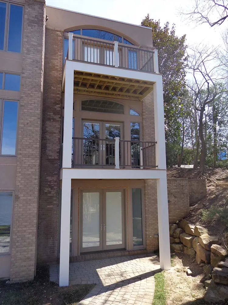 Stacked Composite & PVC Deck that has decks on second and third floor.