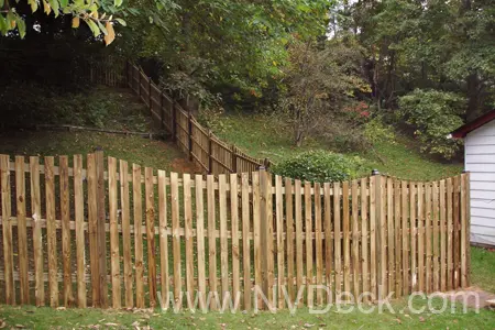 Pressure Treated Pine Fence enclosing a sloped yard.