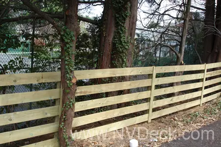 Post and Rail Pine Fence cutting through the woods