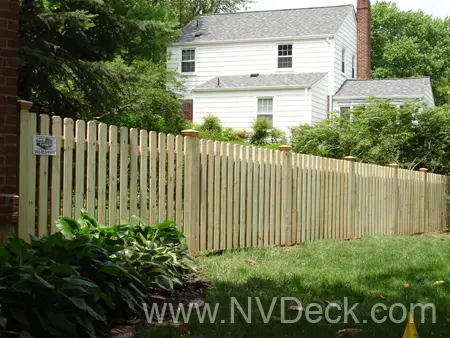 Vertical Plank Pine Fence around white colonial style home