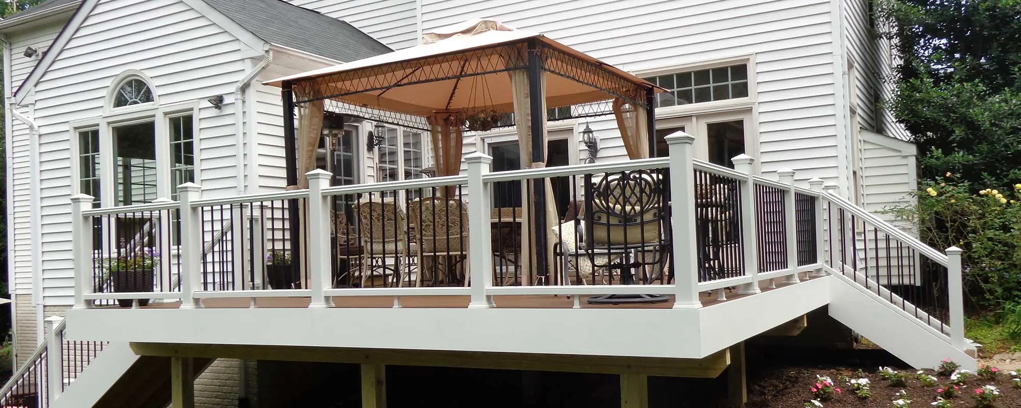 White custom PVC deck awith furniture and drapped canopy